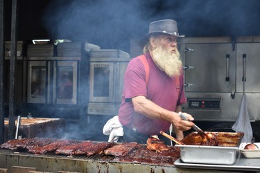 Pete puts the finishing touches on racks of ribs for Kentucky Smokehouse last Civic Holiday weekend. Ten ribbers will be vying for several prestigious awards, including best ribs, best sauce  and peopleÕs choice at this year's annual London Ribfest at Victoria Park Aug. 2-6.
(BARBARA TAYLOR/THE LONDON FREE PRESS)