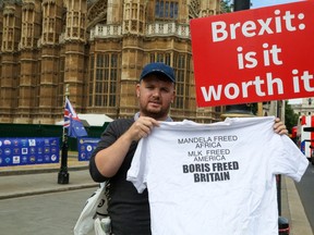 An anti-Brexit campaigner holds a T-shirt outside teh Houses of Parliament following the resignation of Boris Johnson from the U.K. cabinet. (Dinendra Haria/WENN)