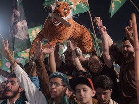 Supporters of Shahbaz Sharif, the younger brother of former Pakistani Prime Minister Nawaz Sharif and head of the Pakistan Muslim League-Nawaz (PML-N), wave party flags as they attend a campaign meeting Sunday ahead of the general election on Wednesday. (IAAMIR QURESHI/AFP/Getty Images)