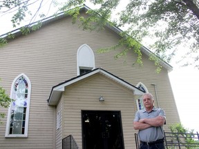 Bryan Prince, a descendant of the original settlers of North Buxton, stands in front of the North Buxton Community Church, that is being taken over by the British Methodist Episcopal Church of Canada. Photo taken in North Buxton, Ont. (File photo)
