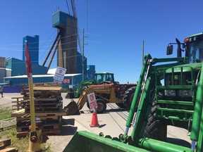 Stacks of wooden pallets striking workers used to block the entrance to the Compass Minerals salt mine in Goderich were replaced on the weekend by tractors and other farm equipment. Unifor invited the community to show support at community barbecues for the 370 workers who have been on strike since April 27. (Shalu Mehta/The London Free Press)