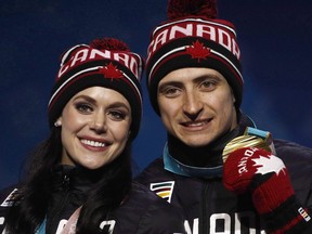 Gold medallists in the ice dance, free dance figure skating Tessa Virtue and Scott Moir, of Canada, pose during their medals ceremony at the 2018 Winter Olympics in Pyeongchang, South Korea, Tuesday, Feb. 20, 2018. Ice skating darlings Virtue and Moir are among the retired all-star athletes hitting the road for a thank you tour. THE CANADIAN PRESS/AP-Charlie Riedel ORG XMIT: CPT112