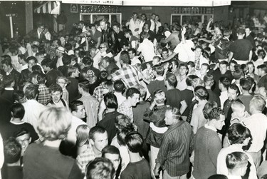 Throngs of young people whoop it up on Main Street in Grand Bend as they blocked off the road suring a Saturday night fracas. Three hours later police had the street clear, 1966 (London Free Press files)