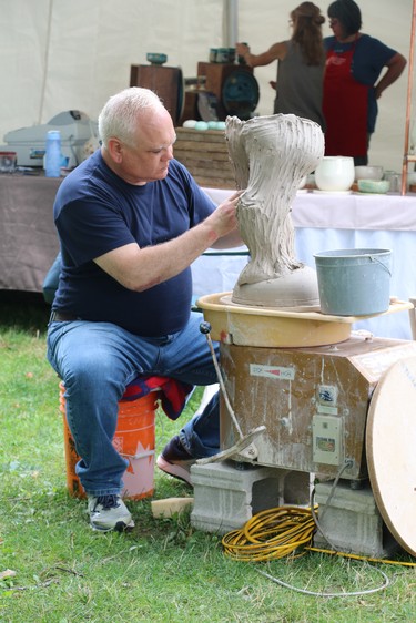 Chris Snedden works on a sculpture Saturday during the Home County Music and Art Festival. (SHANNON COULTER, The London Free Press)