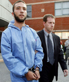 Triple murderer Jesse Imeson is escorted by a local police officer after his arrest following a high-profile nationwide hunt in 2007. (Free Press files)