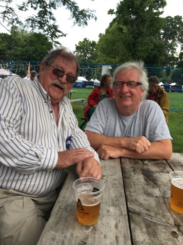 Londoner Walter Grasser, one of the founders of Home County, and singer-songwriter Doug McArthur, who played at the first festival in 1974 and several times since, enjoy a pint in the beer garden while the music plays at Victoria Park. (Joe Belanger, The London Free Press)