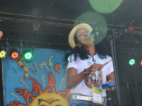 Maria Mercedes Soto of Morena Son, an all-female group from Cuba, performs at Sunfest on Saturday.