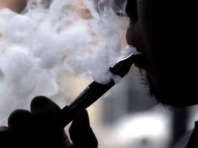 A man smokes an electronic cigarette. THE CANADIAN PRESS/AP-Nam Y. Huh