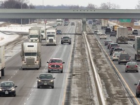 Transport truck and car traffic on the 401 at the Veterans Memorial interchange at the eastern entrance to London. (Mike Hensen/The London Free Press)