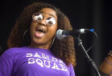 Elana of Samba Squad sings during their traditional Sunfest kickoff concert on the Wellington Street stage on Thursday.  The rain kept the numbers down early in the set. (Mike Hensen/The London Free Press)