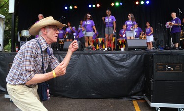 Bev Camp, 72 of London rocks to the beat as Samba Squad performs during their traditional Sunfest kickoff concert on the Wellington Street stage on Thursday July 5, 2018.  The rain kept the numbers down early in the set. Mike Hensen/The London Free Press/Postmedia Network