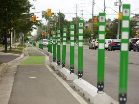 Bike lanes are protected by concrete curbs and flexible signage on Colborne Steet in London (Mike Hensen/The London Free Press)