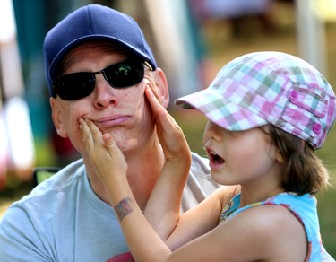 Jamie Williamson of London is easily manipulated by his 3 1/2 year old daughter at Sunfest as they wait for 5 Alarm Funk on Friday July 6, 2018.  Mike Hensen/The London Free Press/Postmedia Network