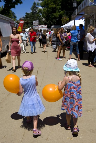 Bethany Pocock, 4 with Sammy Wilson, 4, close family friends walk through the lunch crowds at Sunfest on Friday July 6, 2018 with mom right behind.  (Mike Hensen/The London Free Press)