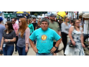 Alfredo Caxaj stands in the crowds at Sunfest on Friday July 6, 2018.  (MIKE HENSEN, The London Free Press)