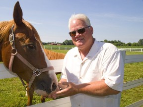 Hugh Mitchell on his farm outside of London with his two horses, Maddie and Nash. Mitchell has retired from the day to day running of the Western Fair District. (MIKE HENSEN, The London Free Press)