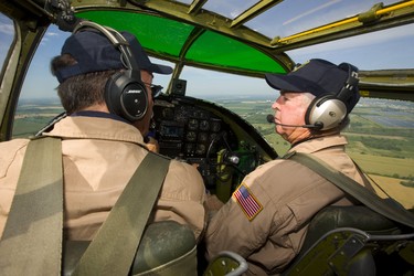 Pilot Richard Petty and pilot and Operations officer Travis Major talk while flying a WWII Mitchell B-25 bomber over Sarnia as part of a tour by the Commemorative Air Force on Thursday July 12, 2018. The B-25 was made famous by the Doolittle Raid, early in WWII after the U.S. was hit by the Japanese at Pearl Harbour, 16 B-25's launched off an aircraft carrier and bombed Tokyo and then ditched their planes in China. Mike Hensen/The London Free Press/Postmedia Network
