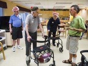 Acting coach Dan Ebbs gives direction to Al Rowe during drama class, at McCormick Home in London, Ont. on Wednesday. Rowe was playing the part of a wealthy man disguised as a poor man while Al Busma (left) and Harry Sing were playing members of the The Pink Hat Gang. (Derek Ruttan/The London Free Press)