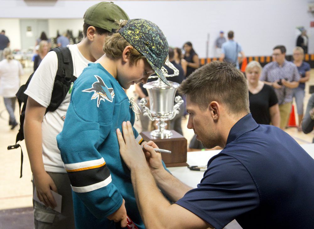 San Jose Shark star player Logan Couture signs the shirt of eleven-year-old Cash Marshall during Fill The Net With Logan Couture Day at the Lucan Community Memorial Centre, just one of the perks of winning the Kraft Hockeyville contest, in Lucan. Couture is Lucan's Hockeyville ambassador. As a child Couture played hockey in Lucan. (Derek Ruttan/The London Free Press)