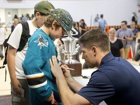 San Jose Shark star player Logan Couture signs the shirt of eleven-year-old Cash Marshall during Fill The Net With Logan Couture Day at the Lucan Community Memorial Centre, just one of the perks of winning the Kraft Hockeyville contest, in Lucan. Couture is Lucan's Hockeyville ambassador. As a child Couture played hockey in Lucan. (Derek Ruttan/The London Free Press)