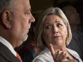 NDP Leader Andrea Horwath gestures towards NDP House Leader Gilles Bisson, left, as they scrum with journalists at Queen's Park, in Toronto on Tuesday, July 31, 2018. The PC Government has refused to answer questions from the official opposition after having accused Bisson of mocking the accent of PC MPP Kaleed Rasheed. THE CANADIAN PRESS/Chris Young