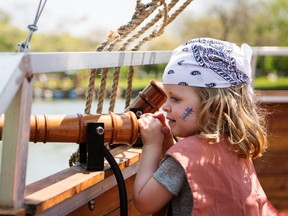 A young member of the pirate crew keeps a lookout with Pirate's Life in Toronto.