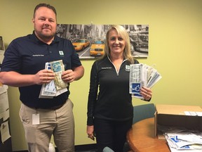 Parking enforcement clerk Sean Steenbergen and division manager Annette Drost go through their haul of seized and counterfeit accessible parking permits. They've issued more than 1,100 accessible parking tickets so far this year. (JENNIFER BIEMAN, The London Free Press)