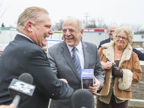 Doug Ford, with his mother Dianne Ford, shakes hands with Dr. Rueben Devlin of Humber River Hospital while making a donation to the hospital in Toronto, Ont. on Wednesday December 17, 2014.