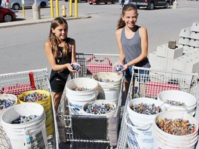Julia Notebomer, left, and sister Eva collected 11,033 batteries throughout the school year for the Zinc Saves Lives Battery Recycling Campaign. (TERRY BRIDGE, Postmedia Network)