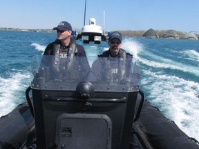 RCMP Const. Craig Sakkit, of Windsor, and Corporal Murray Gordon, of Sault Ste. Marie, are shown in this file photo taking part in a marine training course earlier this year in Sarnia. The RCMP said its Sarnia detachment is scheduled to close. (File photo )