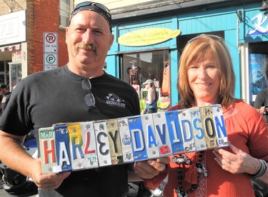 Port Dover merchants David Fett and Cindy Vanderstar have many unique creations for sale at their stores on Main Street. The pair is seen here Friday morning flashing a piece of folk art that would appeal to the many thousands of motorcycle enthusiasts in town for this week’s Friday the 13th motorcycle rally. (MONTE SONNENBERG \ SIMCOE REFORMER)