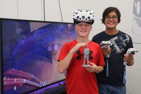 Jacob Clelland, 12, and Gabriel Gualdron, 13, show a 3D print sculpture and some virtual-reality equipment available at Smart Start Tech Camp in London. The camp offers kids the chance to design 3D objects, fly drones, edit videos and play virtual reality games like Camp Grizzly, shown on the television in the background. (SHANNON COULTER, The London Free Press)