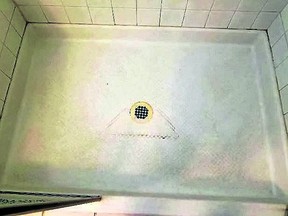 A reader wants to get rid of hard water stains in a fiberglass shower pan. (Reader Photo)
