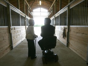 SARI founder Jeanne Greenberg talks to the Honourable David Onley, the Lieutenant Governor of Ontario in the stables after the official ribbon cutting on their newly built facilities north of London. (File photo)