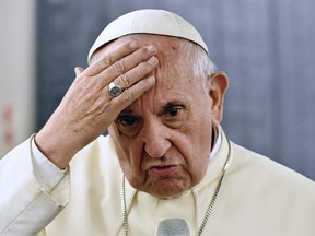 In this file picture taken on January 22, 2018 Pope Francis answers journalists during a press conference on board the plane during his flyback of a seven days trip to Chile and Peru.