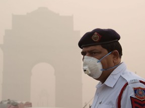 This photo taken on Nov. 9, 2017 shows an Indian police officer wearing a protection mask as he works near India Gate amid heavy smog in New Delhi. India's capital has reeled under dense smog that has disrupted air and railway services and forced residents to stay indoors or wear protection when they venture outside. The city's poor, by contrast, are often unable to buy suitable protection and unaware of the health dangers of the toxic air.         (DOMINIQUE FAGET/AFP/Getty Images)