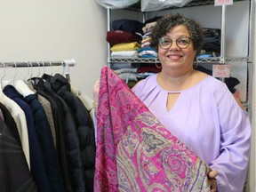 Christina Lord, founder of Christina's Closet, shows off one of the clothing items available at the new Brescia University College service. The closet is designed to offer students new and gently used co-ed clothes, accessories and household items. (SHANNON COULTER, The London Free Press)