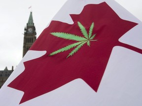 A Canadian flag with a cannabis leaf flies on Parliament Hill during the 4/20 protest, Monday, April 20, 2015 in Ottawa.