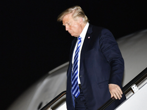 U.S. President Donald Trump steps off Air Force One upon arrival at Andrews Air Force Base after returning from a rally in Charleston, West Virginia, on Aug. 21, 2018.