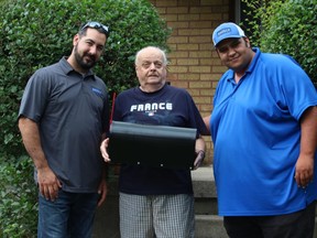 Brosco Concrete owner Marco Antolini, left, stands with Seeley Drive resident Robert Willams and Brosco's business development director, Ali Fayed in front of Williams ' home. Antolini's firm is providing Williams, who lives with his 96-year-old mother, new steps after Canada Post threatened to suspend mail delivery because of safety concerns over the height of his top step.