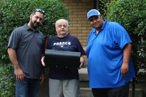 Brosco Concrete owner Marco Antolini, left, stands with Seeley Drive resident Robert Willams and Brosco's business development director, Ali Fayed in front of Williams ' home. Antolini's firm is providing Williams, who lives with his 96-year-old mother, new steps after Canada Post threatened to suspend mail delivery because of safety concerns over the height of his top step.