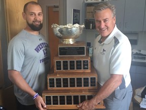 Western Mustangs offensive coordinator Steve Snyder and head coach Greg Marshall hold the Vanier Cup. The defending national champions are early favourites to win back-to-back Canadian titles.

(MORRIS DALLA COSTA, The London Free Press)