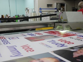 The flatbed UV printer at Fastsigns cranks out a set of sample election campaign signs on Friday, Aug. 3. Despite the explosion of social media and online advertising, old-fashioned election campaign signs seem to be standing the test of time. (MEGAN STACEY/The London Free Press)