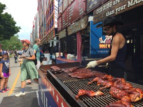 Big Daddy Ben Yo (Skyler Davidson) finishes several racks of Kentucky Smokehouse ribs and chicken, one of 10 ribbers at Victoria Park for London Ribfest and Craft Beer Festival, which continues until Monday.