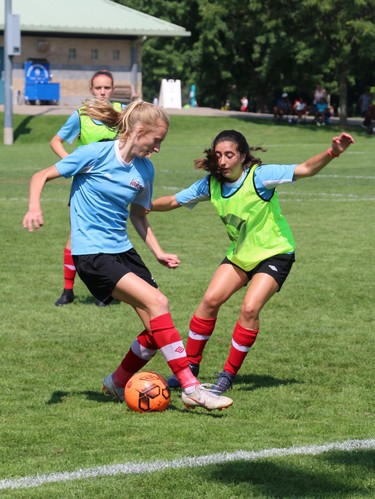 Nicola Golen (left) and Emma Mazzei, both of Toronto, practice drills while warming up before a game on Saturday at North London Athletic Fields. (SHANNON COULTER, The London Free Press)