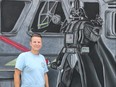 Krystal Caldwell stands with her Darth Vader masterpiece she created for this year's Expressions in Chalk street art festival. Caldwell was also a judge for the festival, where artists created oversized masterpieces on the Victoria Park ice pad. (SHANNON COULTER, The London Free Press)