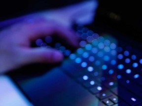 A hand at a laptop keyboard is shown in this 2016 file photo.