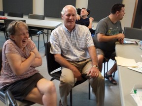 Raymond Dilling, centre, jokes around with clients at L'Arche Gathering Place in Lambeth. Philanthropist Arthur Labatt recently pledged to match donations dollar-for-dollar to push the $2.5 million campaign over the top. (DAN BROWN, The London Free Press)