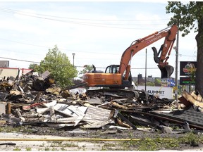 Heavy machinery digs through the remnants of the former Hooks Restaurant on Wednesday, May 30, 2018. (Derek Ruttan/The London Free Press)