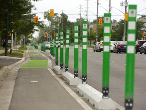 Bike lanes protected by concrete curbs and flexible signage on Colborne Steet in London. (Mike Hensen/The London Free Press)